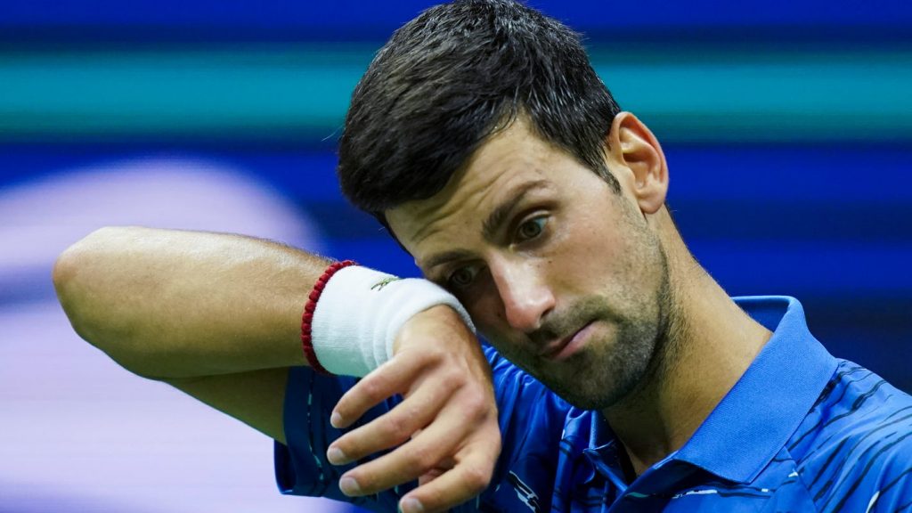 Djokovic at the US Open, wiping the sweat off his forehead.