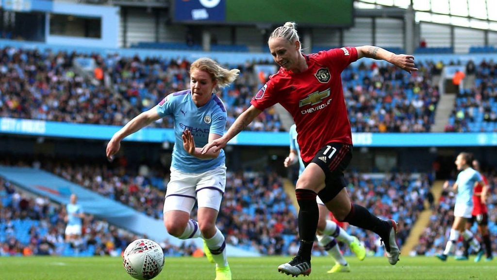 Manchester City and Manchester United female soccer players chasing after a ball on Sunday, September 8, during the opening game of the Women's Super Liga.