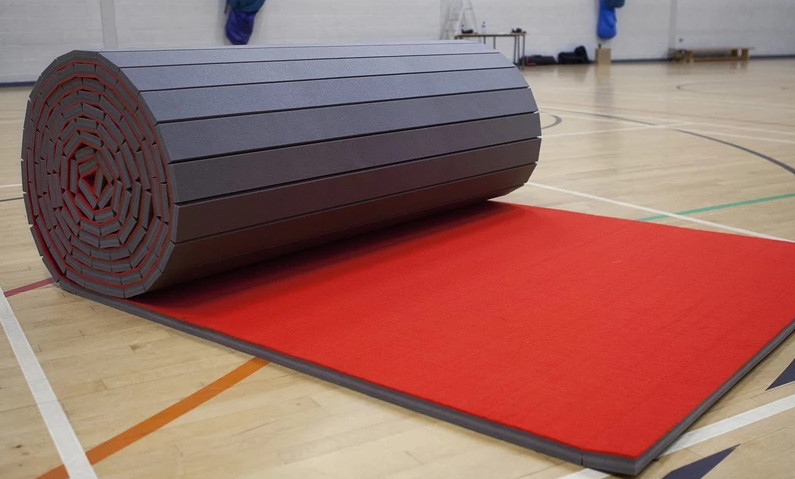 A training pad in a gym rolling out